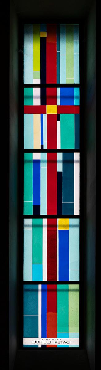 Long narrow window of multicolored glass.