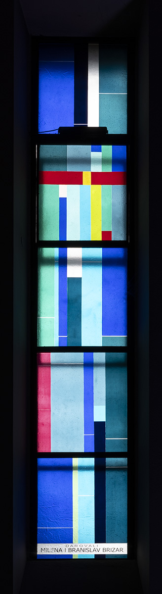 Long narrow window of multicolored glass.