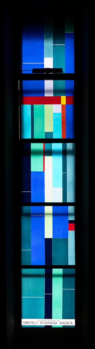 Long narrow window of multicolored glass.